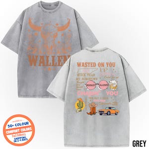 May include: Grey t-shirt with a distressed design. The front features a bull skull graphic and the word "WALLEY" in orange. The back displays text and graphics including "WASTED ON YOU" and "CHASIN' YOU".