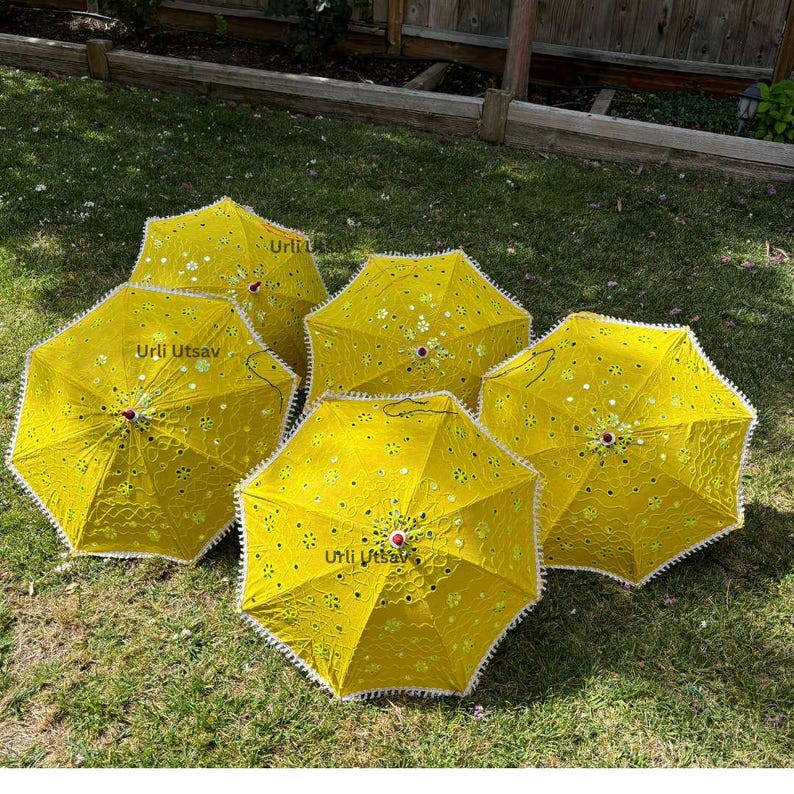 Artisanal yellow Mehendi umbrella showcasing mirror embellishments, ideal for Indian wedding ceremonies