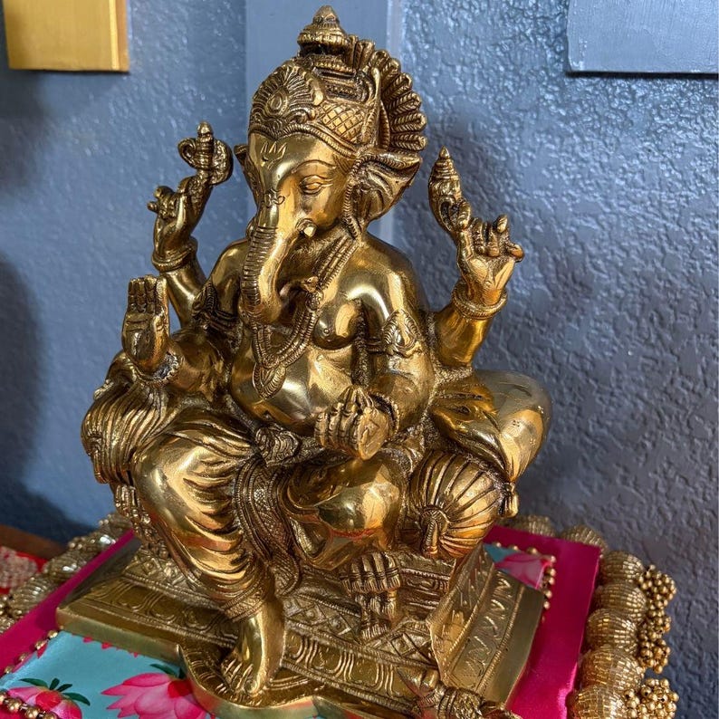 Brass Ganesha on colorful fabric close-up — perfect for Diwali and Ganesh Chaturthi displays