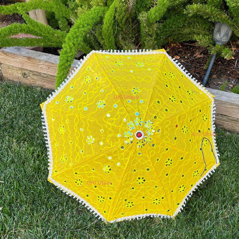 Vibrant yellow umbrella with detailed embroidery, suitable for enhancing wedding parasol decor