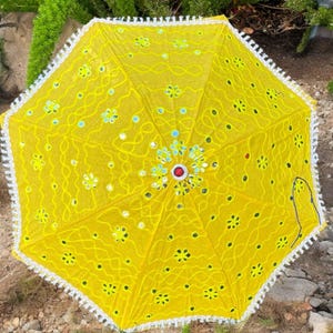 Yellow Haldi umbrella with handcrafted designs, suitable for use as a Mehendi prop