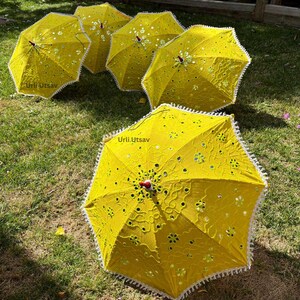 Decorative yellow umbrella featuring intricate patterns, ideal for wedding parasol arrangements