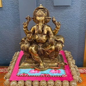 9.5" Brass Ganesha Statue antique gold finish on pink-blue platform — handcrafted Ganesh idol for home decor