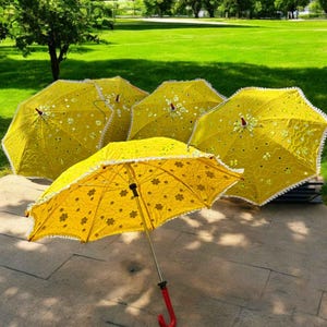 Handcrafted yellow Haldi umbrella featuring traditional Indian designs, perfect as a Mehendi prop