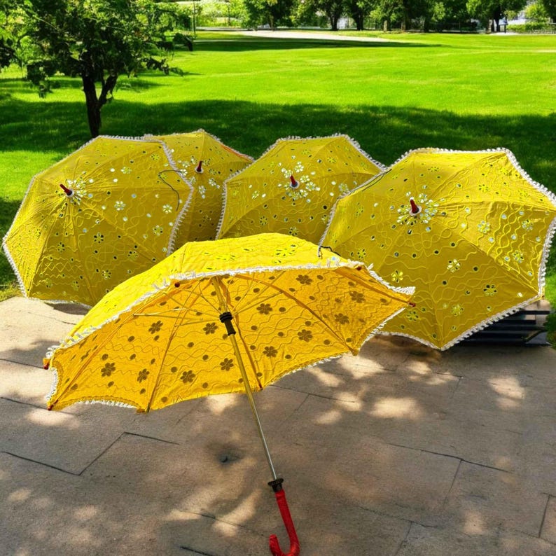 Handcrafted yellow Haldi umbrella featuring traditional Indian designs, perfect as a Mehendi prop