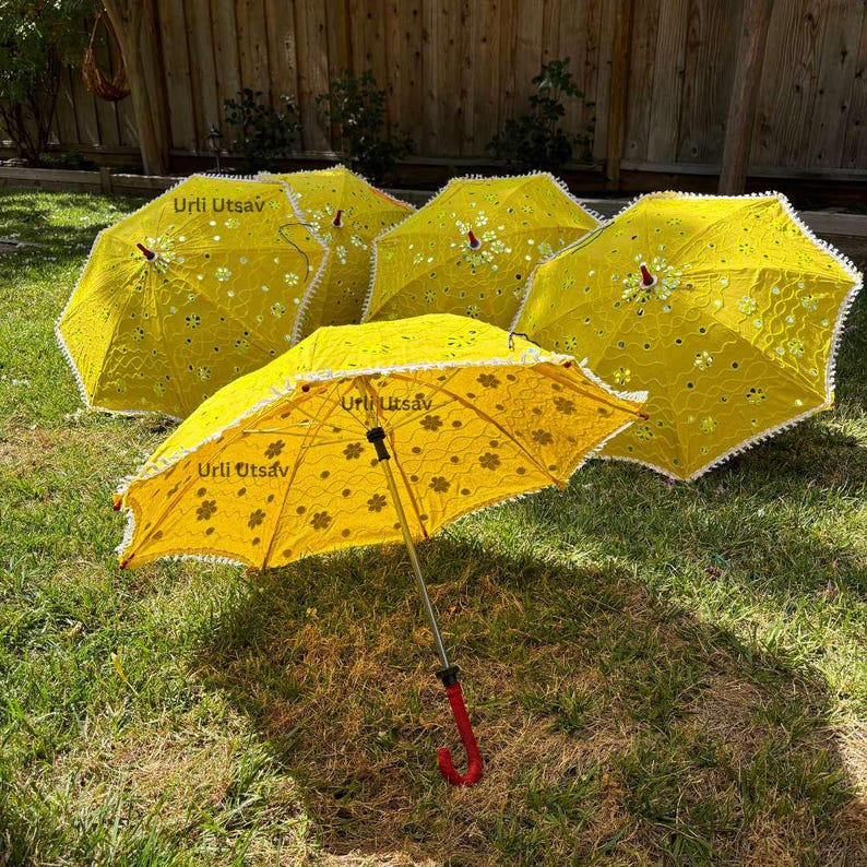 Bright yellow Mehendi umbrella adorned with mirror work, suitable for Indian wedding celebrations
