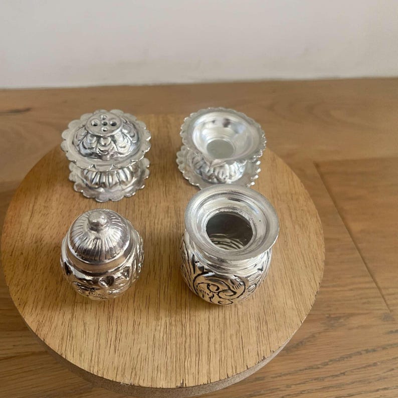 Antique silver-plated pooja accessories including a 3-inch Kalash lota, incense holder, and mini oil stand with intricate handmade engravings.