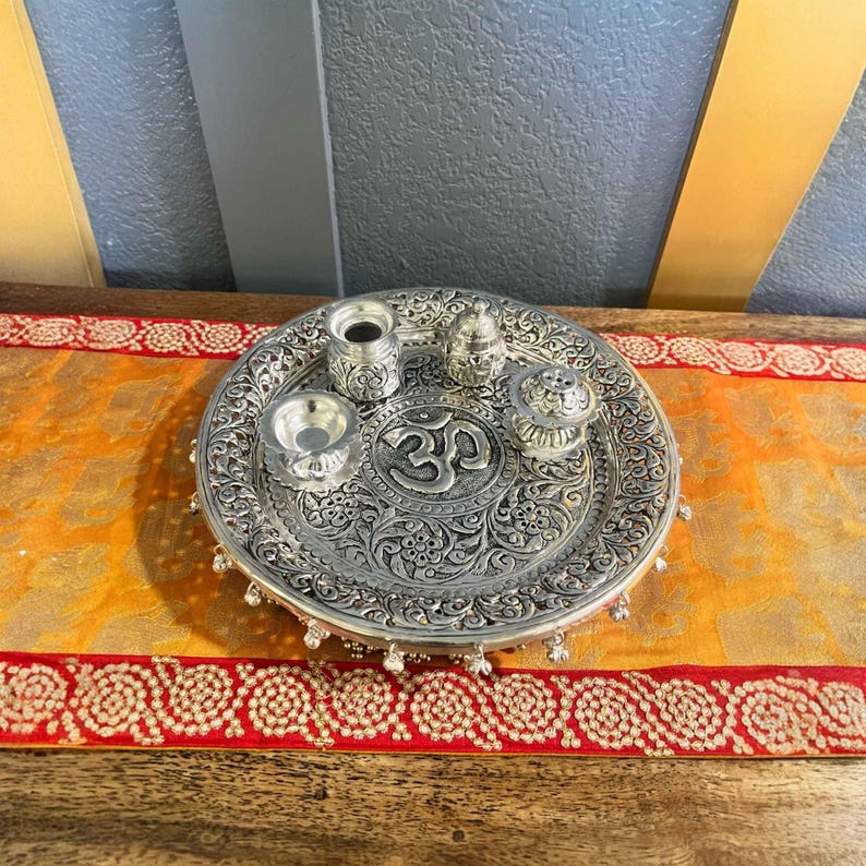 Elegant silver pooja thali set arranged for a spiritual ritual, perfect for Diwali gifting or housewarming celebrations.