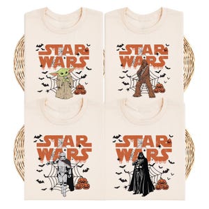 four white t-shirts with various Star Wars characters printed on them, including Yoda, Chewbacca, Darth Vader, and Baby Yoda.