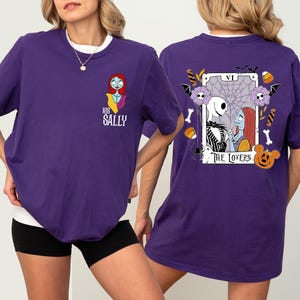 a woman wearing a purple t-shirt with a design on the back.