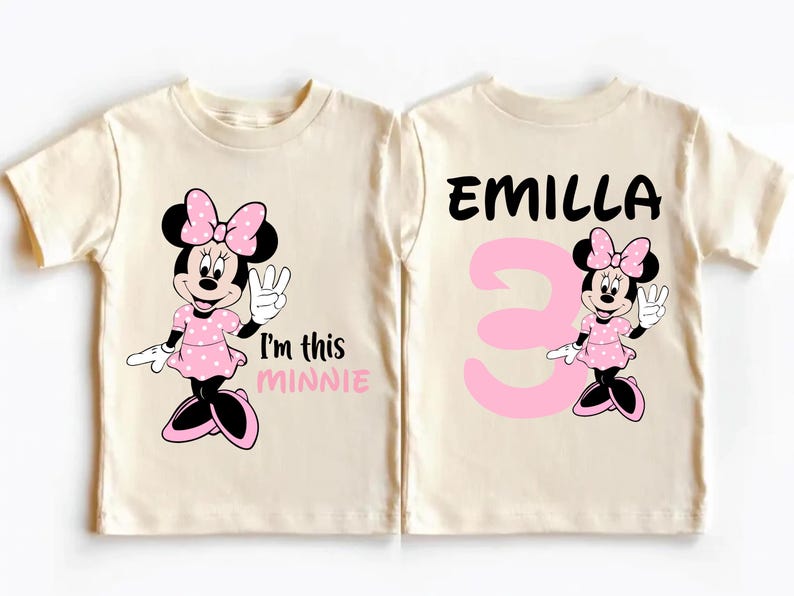 two white t-shirts with a Minnie Mouse design and text. The text on the t-shirts reads "I'm this MINNIE" and "EMILLA 3".