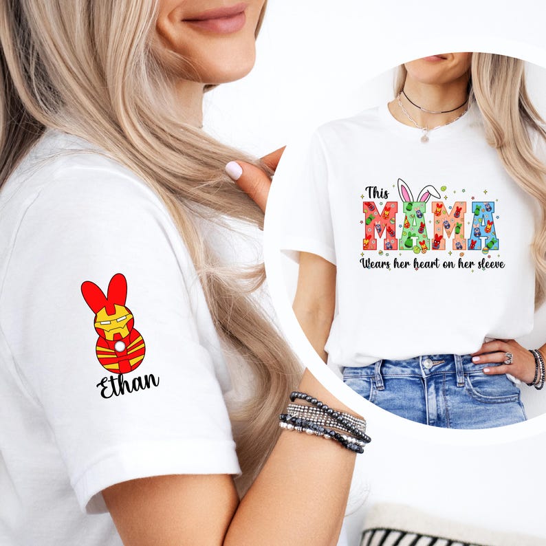 A woman wearing a white t-shirt with a colorful Easter bunny design and the text "This MAMA wears her heart on her sleeve" printed on it.