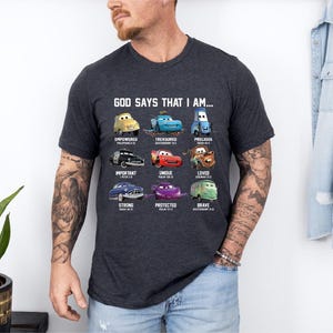 A man wearing a t-shirt with a graphic design of various Disney Cars characters and text that says "God says that I am..."