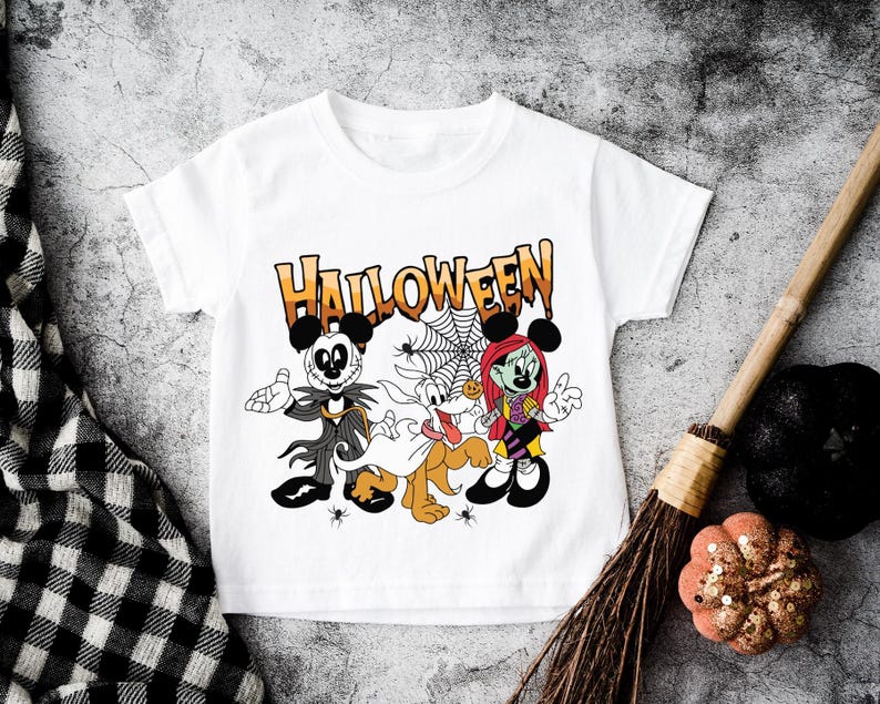A white t-shirt with a Halloween-themed graphic design featuring characters from the Disney movie " jack Skellington and Sally" and a spider web.