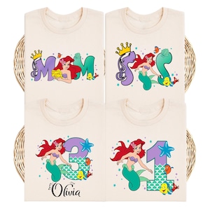 four t-shirts with the same design featuring a mermaid character and the number 3.
