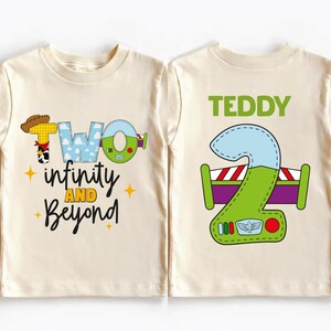 two white t-shirts with colorful designs and text on them.