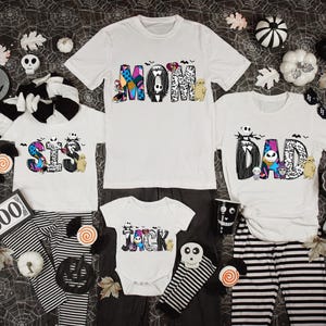 Halloween-themed family clothing, including t-shirts, pajamas, and other accessories, arranged on a spider web background.