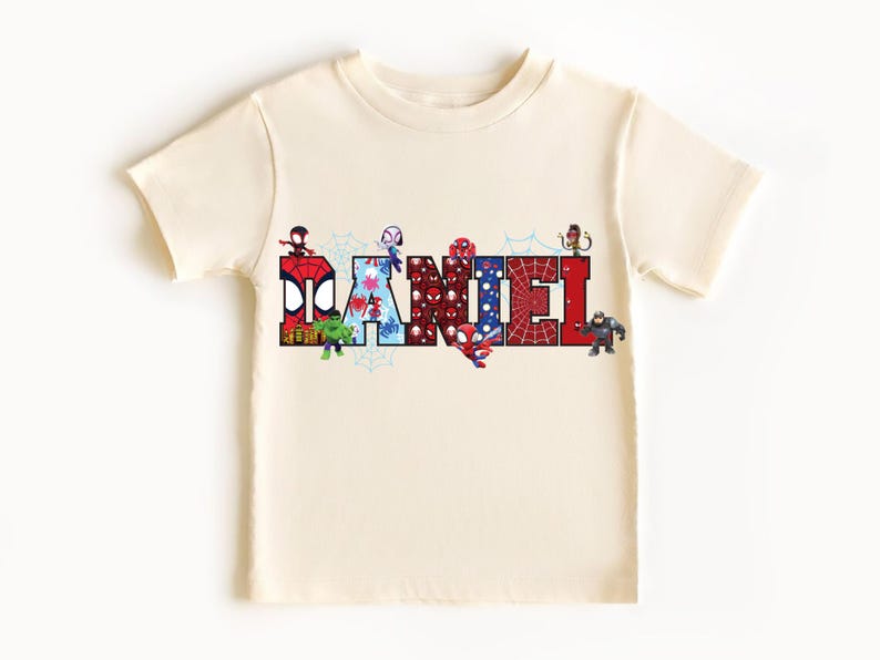 A white t-shirt with the name "DAMNEL" printed on it, made up of various cartoon character images.