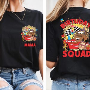 a woman wearing a black t-shirt with a graphic design on the back, depicting a birthday celebration with a car and the text "MAMA SQUAD".