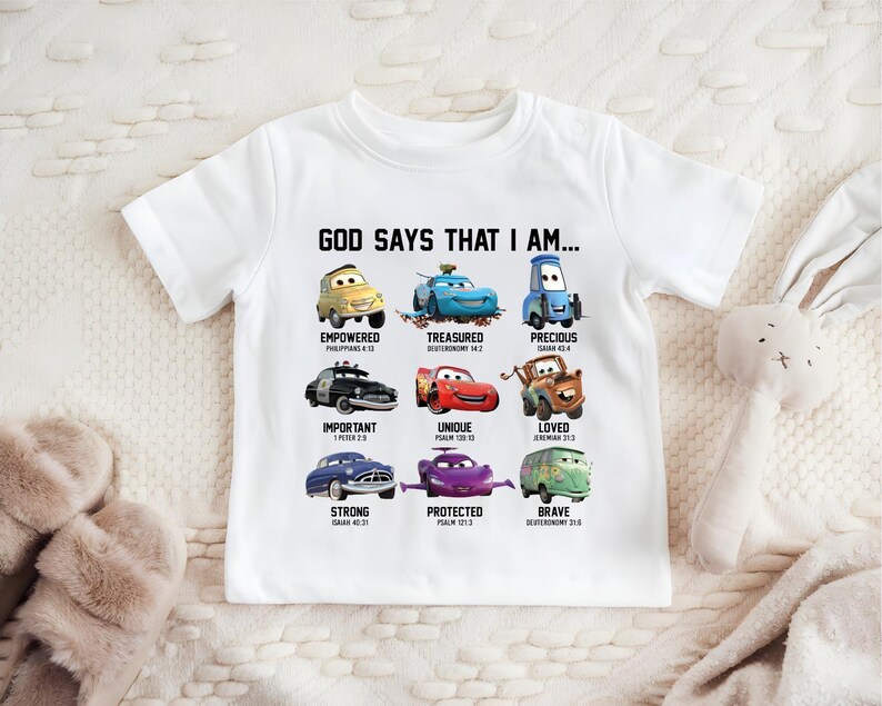 A white t-shirt with a graphic design featuring various cartoon cars and their Bible verse titles.