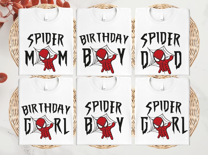 six white t-shirts with the text "SPIDER MOM" and "SPIDER BOY" printed on them, along with a Spider-Man graphic.