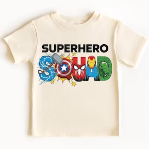 A white t-shirt with the text "SUPERHERO SQUAD" printed on it, featuring various superhero characters such as Captain America, Spider-Man, Iron Man, and Hulk.