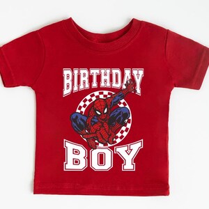 A red t-shirt with a Spider-Man graphic and the text "BIRTHDAY BOY" printed on it.
