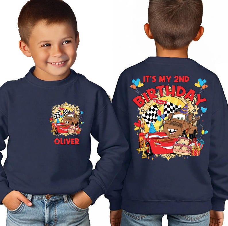 A young boy wearing a blue sweatshirt with a personalized design featuring a character from the Cars movie franchise.