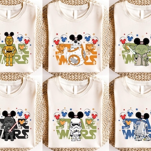 six white t-shirts with various Star Wars characters and designs printed on them.