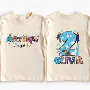 two white t-shirts with birthday-themed designs. The t-shirt on the left has the text "BIRTHDAY girl" and the t-shirt on the right has the text "OLIVIA 2".