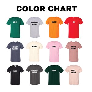 a collection of 12 t-shirts in various colors, including green, light gray, orange, red, natural, pink, mauve, dark gray, forest, peach, and black.