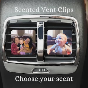 May include: Two square car air freshener vent clips with rounded corners, featuring custom photo prints of people and a baby. The clips are attached to a vehicle air vent with chrome trim. Text on the image reads Scented Vent Clips and Choose your scent.