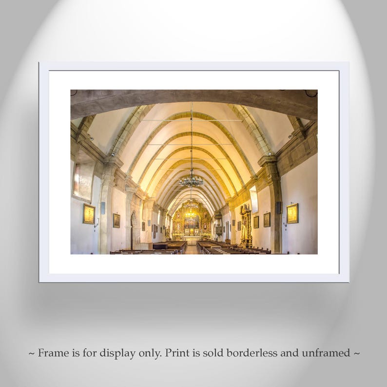 May include: A photograph of the interior of a church with a vaulted ceiling and rows of pews. The church is brightly lit with natural light.