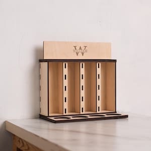 May include: Wooden stand with six slots for storing items, featuring a personalised engraved top panel with the name "William" and the initial "W".
