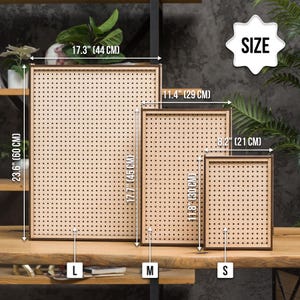 May include: Three wooden pegboards in different sizes, labeled "L", "M", and "S". The largest pegboard is 23.6 inches by 17.3 inches, the medium pegboard is 17.7 inches by 11.4 inches, and the smallest pegboard is 11.8 inches by 8.2 inches.
