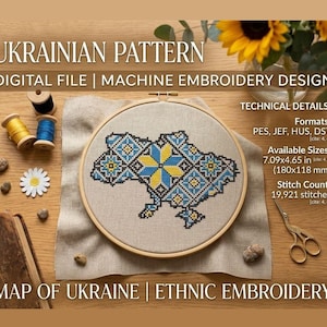 May include: An embroidery hoop with a cross-stitch map of Ukraine in blue and yellow. The design is labelled "UKRAINIAN PATTERN" and "MAP OF UKRAINE | ETHNIC EMBROIDERY". The design measures 180x118 mm. The image includes spools of thread and a pair of scissors.