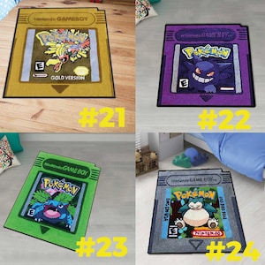 May include: A collection of four rectangular rugs shaped like Nintendo Game Boy game cartridges. Each rug features a unique Pok&eacute;mon character illustration, including Ho-Oh, Gengar, Venusaur, and Snorlax, with the text Nintendo GAME BOY.
