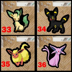 May include: A set of four character-shaped rugs featuring Leafeon, Umbreon, Flareon, and Espeon. Each rug is outlined in black and labeled with a red number: 33 for the cream and green Leafeon, 34 for the black and yellow Umbreon, 35 for the yellow and orange Flareon, and 36 for the light purple Espeon.