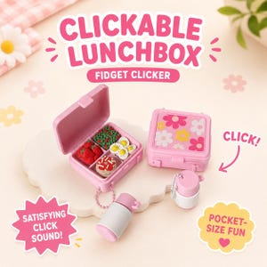 May include: Two pink plastic lunchbox fidget clickers with miniature food items inside, including strawberries, broccoli, and eggs. One box is open, one is closed with a floral pattern, and two small white and pink containers are attached by chains.