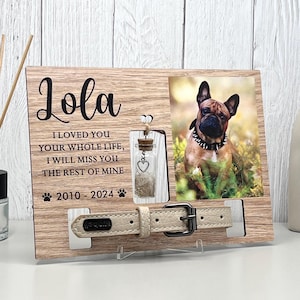 May include: A wooden pet memorial frame with a photo of a dog, a small glass bottle, and a beige dog collar. The frame includes the name "Lola" and the text "I loved you your whole life, I will miss you the rest of mine 2010-2024."