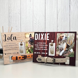 May include: Two wooden pet memorial frames with photos of dogs, names, and dates. Each frame has a small glass bottle with a heart charm and a dog collar. One collar is orange, the other is beige.