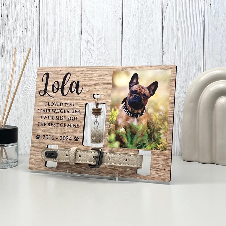 May include: Wooden pet memorial frame with a photo of a dog, a small glass vial, and a dog collar. The frame includes the name "Lola", the years 2010-2024, and the text "I LOVED YOU YOUR WHOLE LIFE, I WILL MISS YOU THE REST OF MINE."