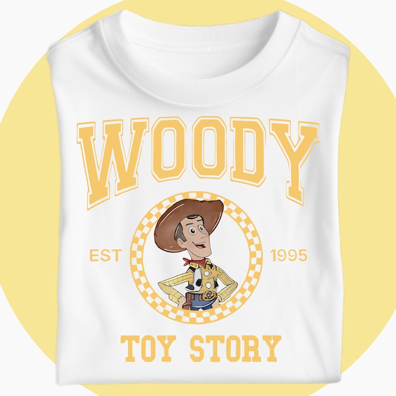 May include: White t-shirt with a cartoon illustration of Woody from Toy Story. The design features the word "WOODY" in yellow block letters above a circular image of the character, with "EST 1995" and "TOY STORY" below.