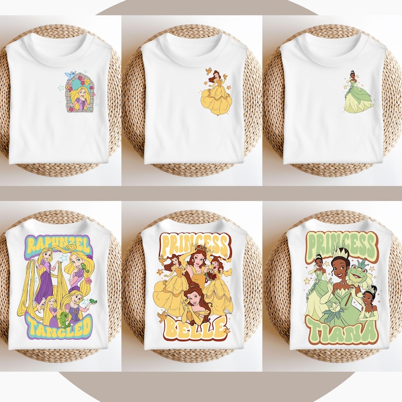 May include: Six white t-shirts featuring different Disney princess designs. The shirts depict Rapunzel, Belle, and Tiana. The designs are in a retro style with colourful graphics and text.