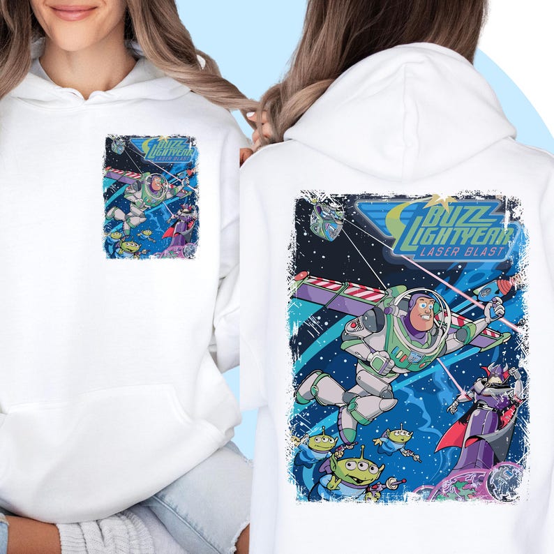 May include: White hoodie with a graphic print of Buzz Lightyear from Toy Story. The graphic shows Buzz in space with his spaceship and other characters. The text "Buzz Lightyear Laser Blast" is printed on the graphic.