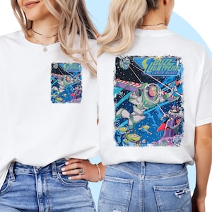 May include: White t-shirt with a graphic print of Buzz Lightyear from Toy Story. The graphic features Buzz Lightyear in space with the text "Buzz Lightyear Laser Blast".