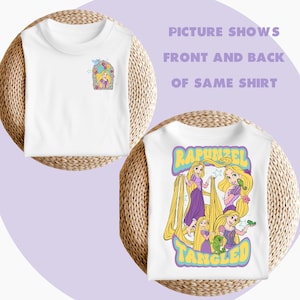 May include: White t-shirt featuring a graphic of Rapunzel from the film Tangled. The front of the shirt has a small image of Rapunzel in a window, while the back of the shirt has a larger image of Rapunzel with her long hair and a chameleon.