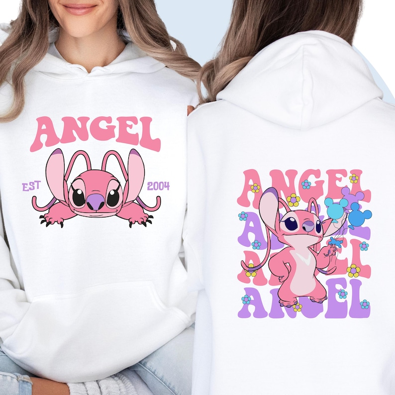 May include: White hoodie with a pink Stitch character and the text "ANGEL EST 2004" on the front. The back of the hoodie features a pink Stitch character with the text "ANGEL" repeated in a colorful, retro font.