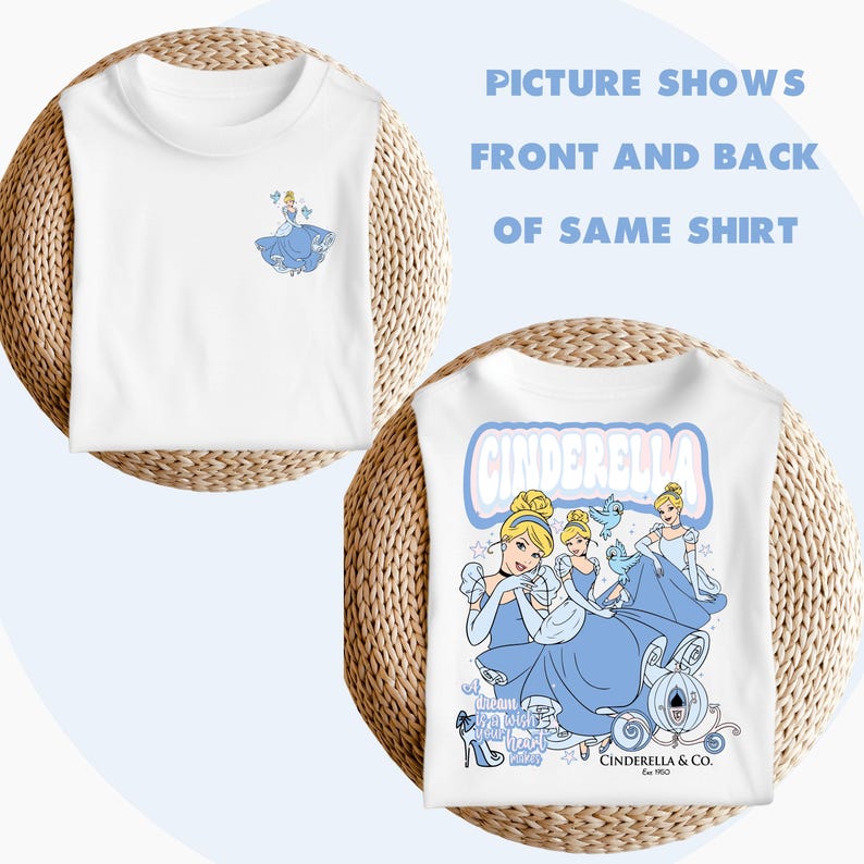 May include: White t-shirt featuring a graphic print of Cinderella in a blue dress and a crown. The text "Cinderella" is printed in pink and blue letters on the back of the shirt. The text "Let dream take you to where your heart belongs" is printed on the bottom of the shirt.