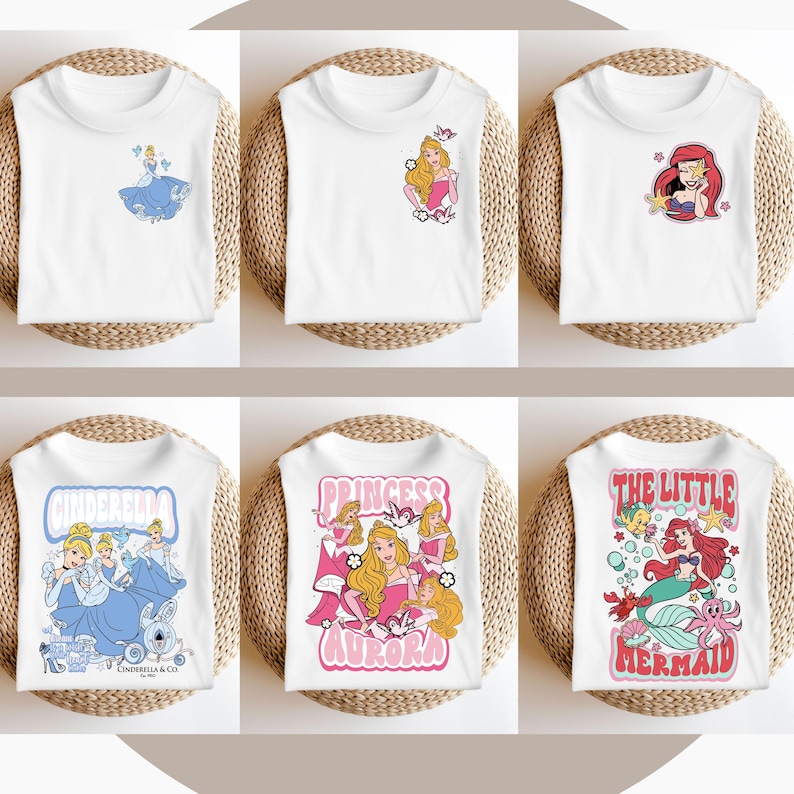 May include: Six white t-shirts featuring different Disney princess designs. The designs include Cinderella, Aurora, and Ariel. The shirts are all white with a variety of colours in the designs.